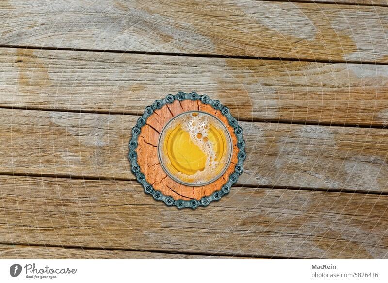 Biker beer mat on a wooden table Beer coaster Table Wooden table Bicycle chain Beer glass Coaster Beverage