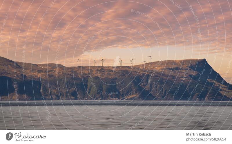 Wind turbines on a mountain on a fjord off the open sea in Norway. Renewable Fjord windmill energy electricity mountains nature Scandinavia landscape tourism