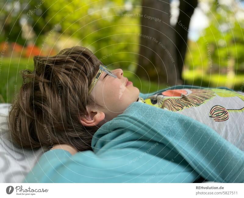 Boy lying on a meadow with his eyes closed happy child Child Boy (child) naturally 3 - 8 years Infancy Exterior shot Head portrait Human being