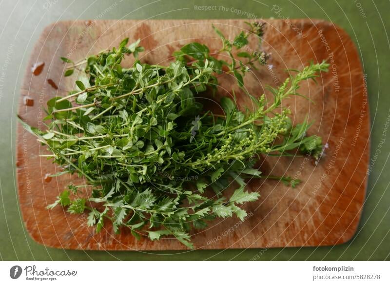 Herbs on a wooden board herbs Wooden board Chopping board Pimpernel Thyme Fresh salubriously Green kitchen herbs Herbs and spices Healthy Eating Spicy Kitchen