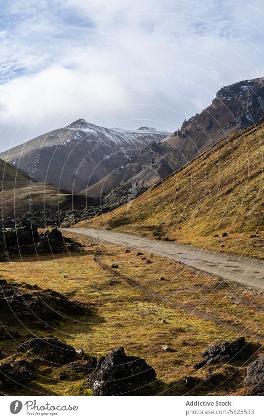 Scenic road in the Iceland Highlands with mountain views iceland highlands scenic landscape snow-capped rugged terrain clouds sky outdoor nature travel serenity