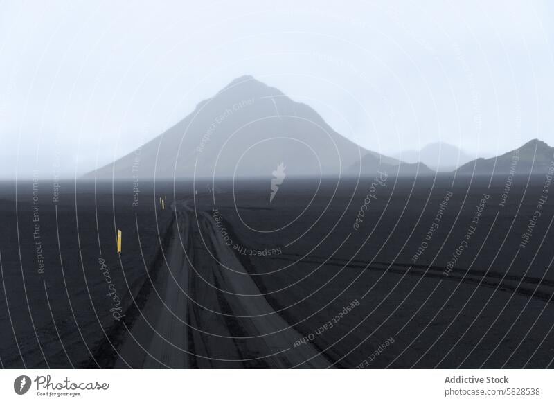 Misty Road Leading to Mountain in Iceland Highlands iceland highlands mountain road mist isolation adventure landscape desolate travel nature fog pathway