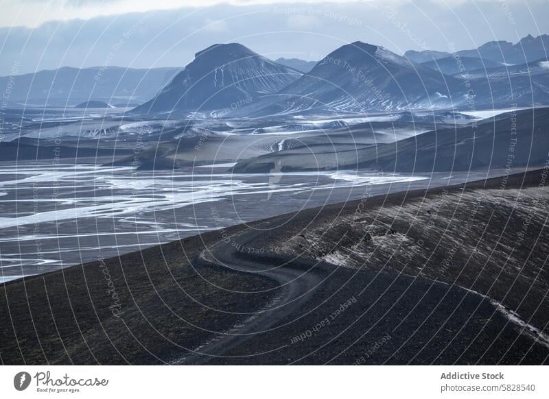 Moody Highlands Road in Iceland's Remote Terrain iceland highlands road landscape rugged moody sky terrain desolate winding outdoor mountain volcanic natural