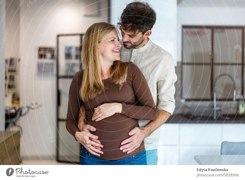 Portrait of a loving couple expecting a baby pregnancy pregnant adult anticipation awaiting belly birth body care caucasian child expectant expectation family