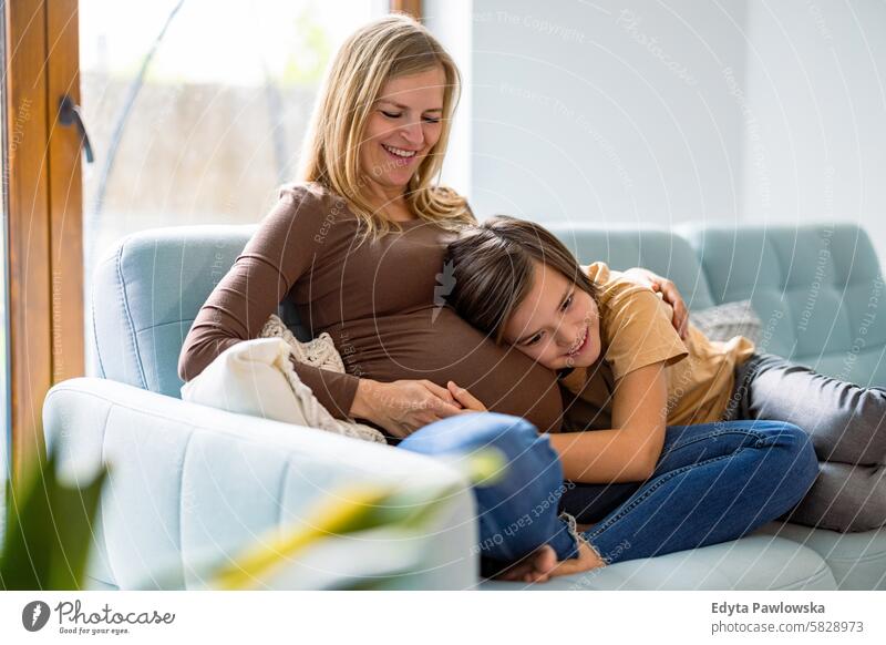 Little boy with his pregnant mother at home pregnancy adult anticipation awaiting baby belly birth body care caucasian child expectant expecting expectation