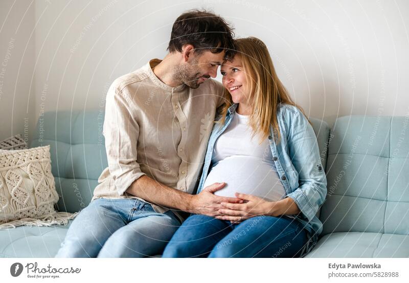 Portrait of a loving couple expecting a baby pregnancy pregnant adult anticipation awaiting belly birth body care caucasian child expectant expectation family