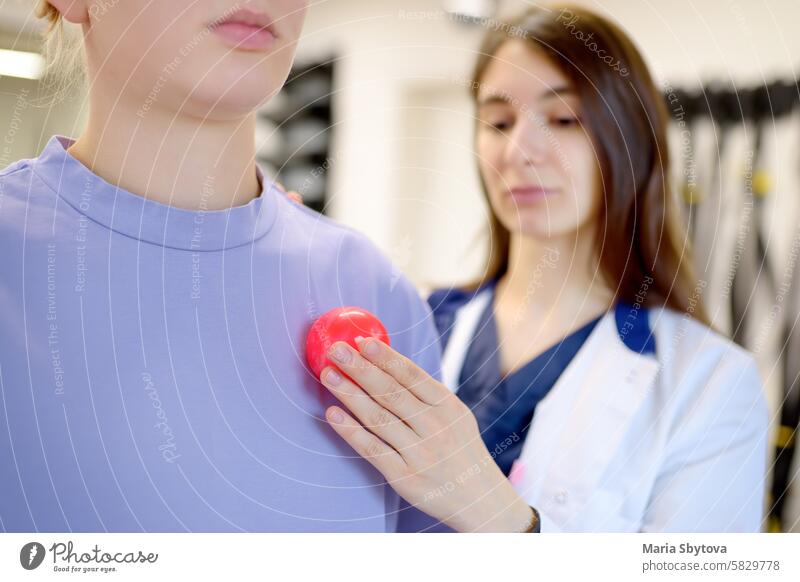 The rehab doctor conducts the patient's appointment in the gym. The PMR specialist trains the patient to perform recovery exercises correctly. physical medicine