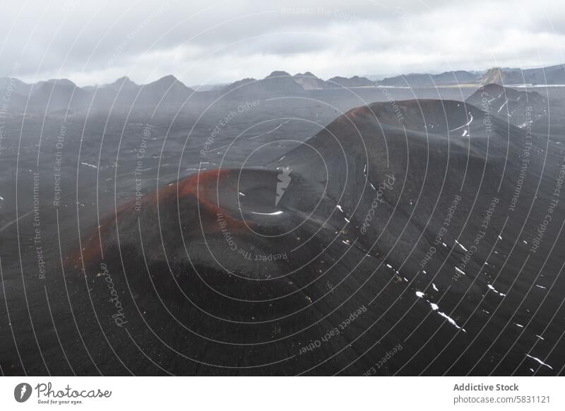 Misty volcanic landscape in the Highlands of Iceland iceland highlands volcano mist expansive view cloudy sky bleak dramatic terrain ash lava mound crater hill