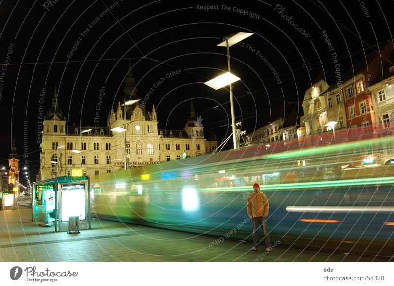 rush hour Long exposure Light Tram Driving Railroad tracks Main square Graz Night Man Stand Building Historic Movement Lighting Lamp Station Wait