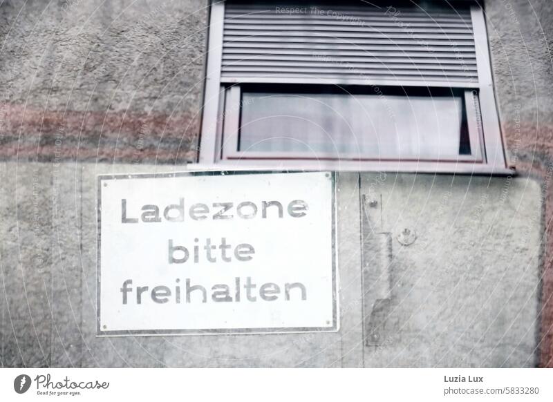 Please keep loading zone clear - sign photographed through the window of a car parked in front of it Ravages of time Safety loading area Arrangement No standing