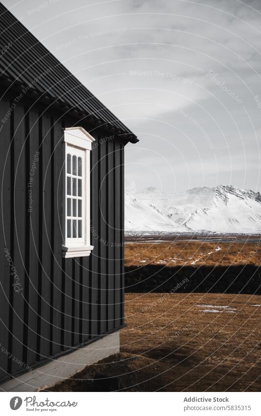 Traditional Icelandic Cottage Against Snowy Mountain View icelandic cottage traditional snaefellsnes peninsula mountain snow backdrop architecture black white