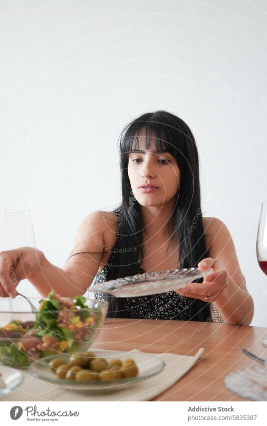 Young woman enjoying a healthy meal at home salad dining lifestyle peaceful healthy eating dinner lunch glass bowl transparent serving focus young tranquil