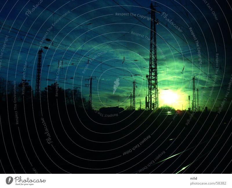 Sunpoint III Railroad tracks Clouds Moody Back-light Green Calm Pasing Light and shadow Wanderlust Commute Public transit Munich Dark Cable Electricity pylon