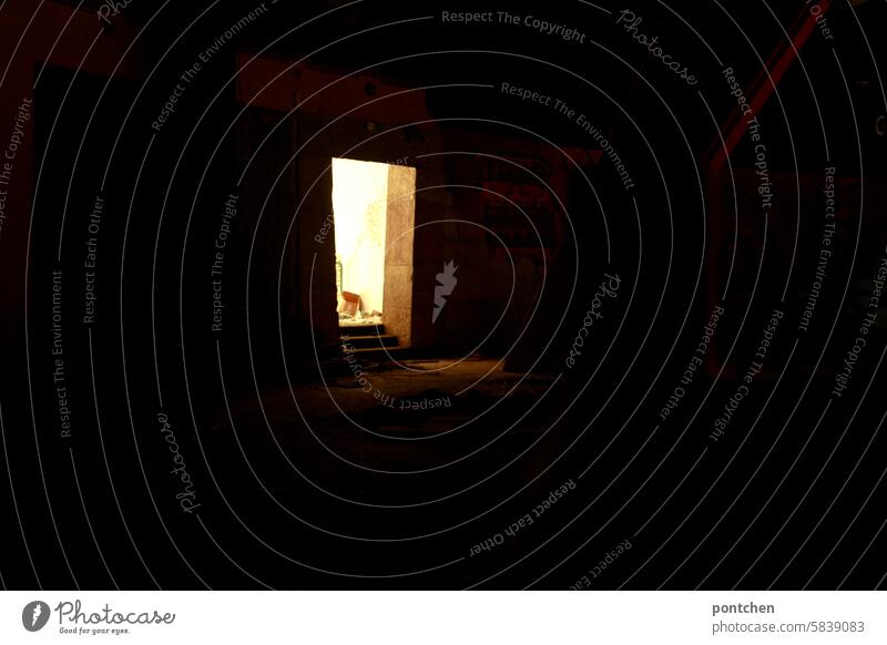 Light in the dark. Incidence of light through an open door in a dark lost place darkness symbolic forsake sb./sth. Shaft of light Sunlight Decline Transience