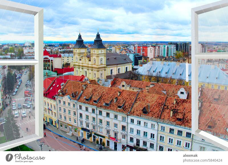 opened window with view to Ivano-Frankivsk panorama city street urban birds-eye view frame buildings cars neighbour metal-plastic windows boisterous society