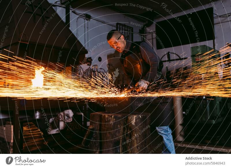 Blacksmith working with molten metal at the forge blacksmith sparks craftsmanship skill heat male hot iron fire anvil hammer workbench industrial workshop