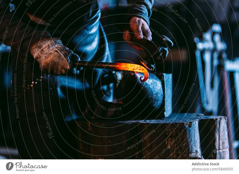 Blacksmith shaping hot metal on anvil in workshop blacksmith hammer shape glowing craftsmanship skill tradition handmade metalwork heating forging manual labor