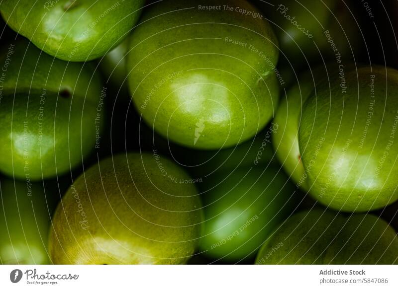 Organic green plums close-up, a staple in Eastern cuisine organic fresh pile bowl eastern culinary tradition georgia turkey greece fruit ripe raw natural