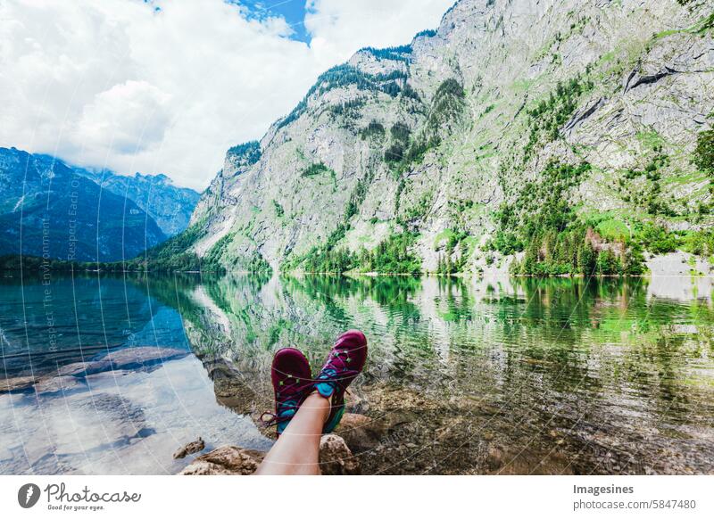 Woman relaxing at Obersee Königssee, Berchtesgadener Land, Bavaria, Germany Lake Königssee Berchtesgaden Country Lake Obersee Relax woman relaxation Legs tucked