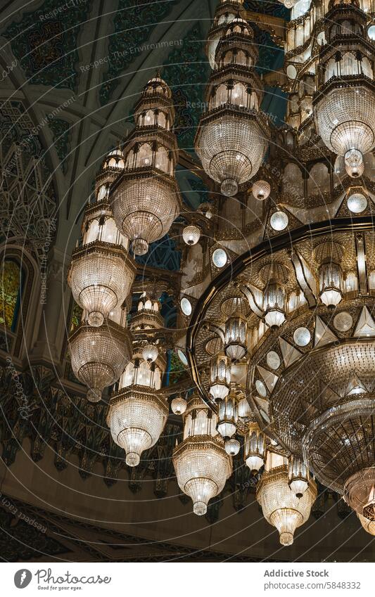 Grand chandeliers in ornate Oman mosque interior oman ceiling islamic design craftsmanship elegant cascade decor architecture light fixture cultural islamic art