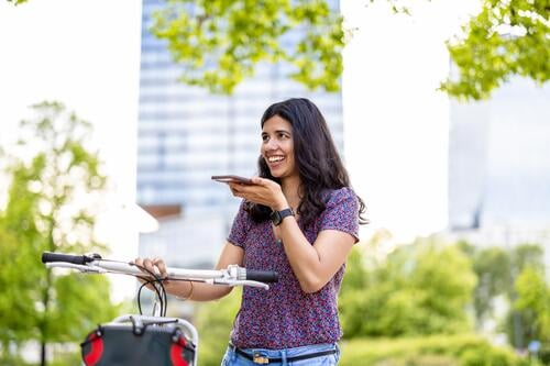 Portrait of happy woman with bicycle in the city Indian real people fun summer enjoying street travel outdoors urban adult young adult attractive authentic