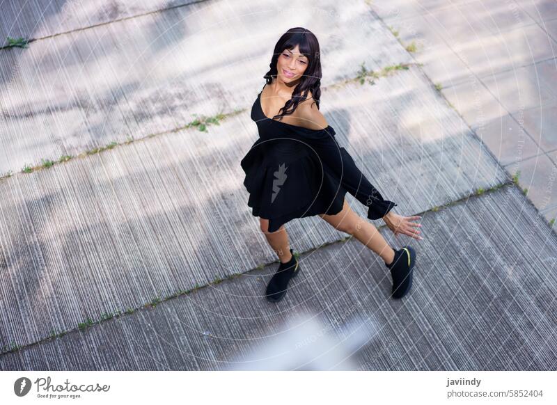 Glamorous dancer performing looking up on the street top view caucasian beauty woman glamorous urban graceful elegant dynamic movement stylish confident chic