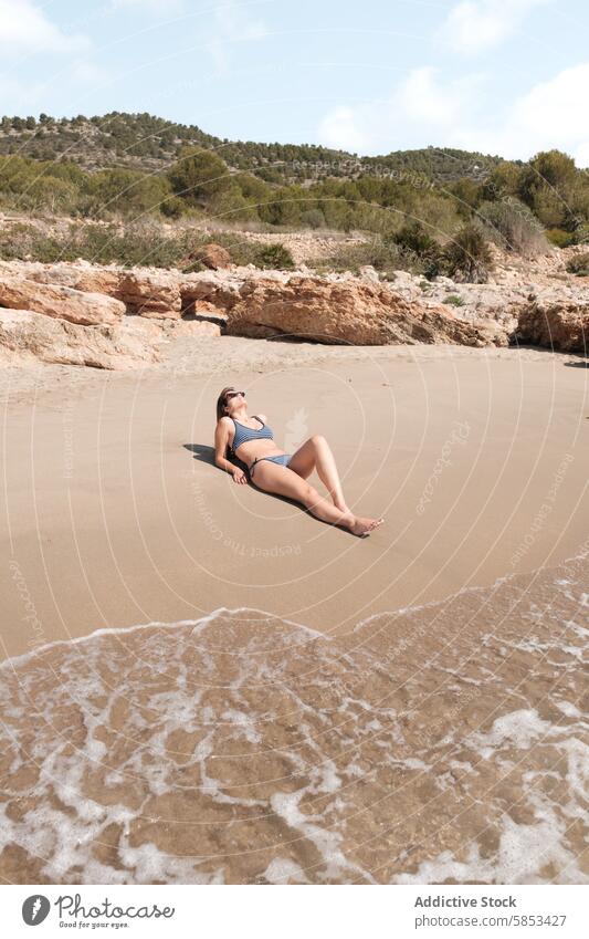 Serene Beach Relaxation with Sunbathing Woman beach woman sunbathing relaxation tranquil sandy gentle wave nature isolated serene outdoors leisure summer