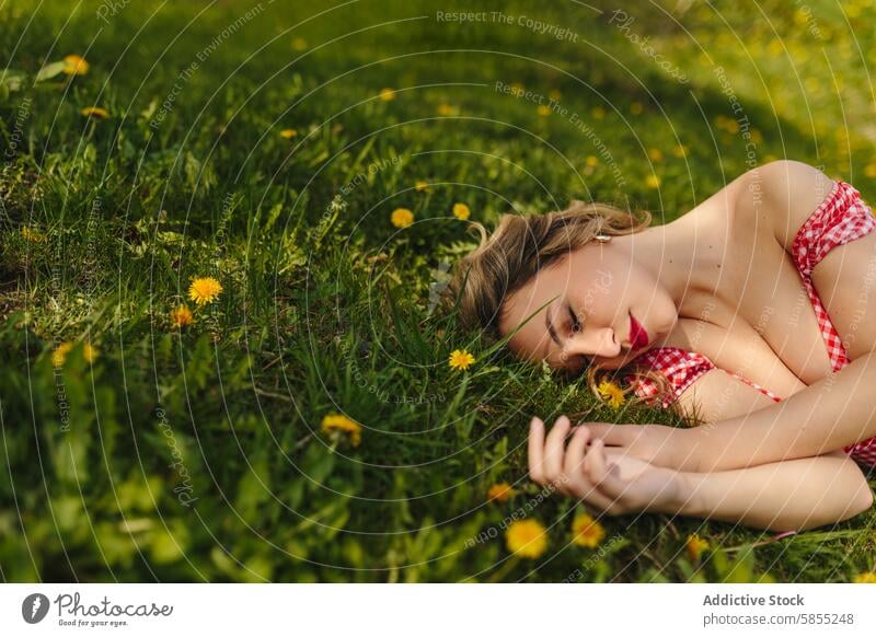 Woman relaxing alone in grassy field with dandelions woman sunlight serene peaceful relaxation summer nature outdoors green floral contemplation young female