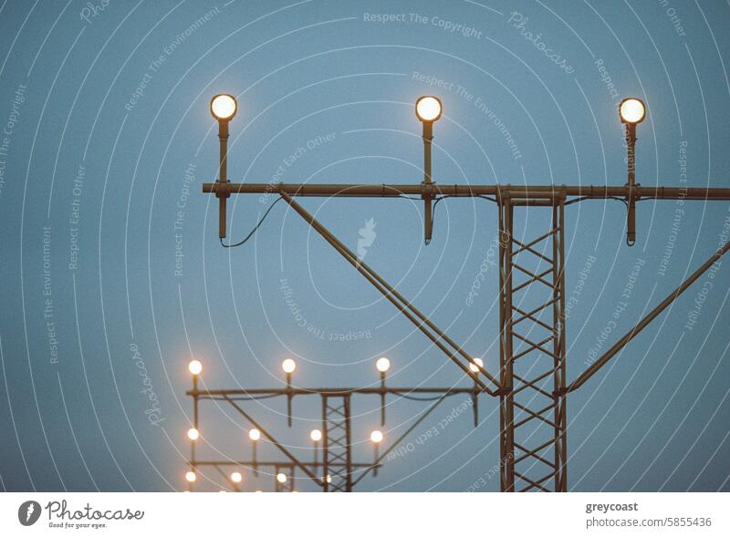 Illuminated Approach Lights airport approach lights film dusk twilight fog illuminated metal structure close-up evening navigation tower safety runway aviation