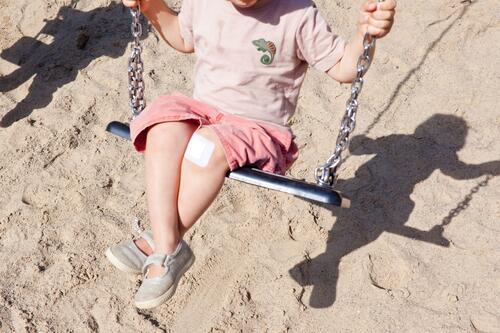 Grandson on the swing (with a plaster on his knee) chamissoplatz Only child Family holidays Child children's playground Toddler Light Sand Sandpit Shadow Swing