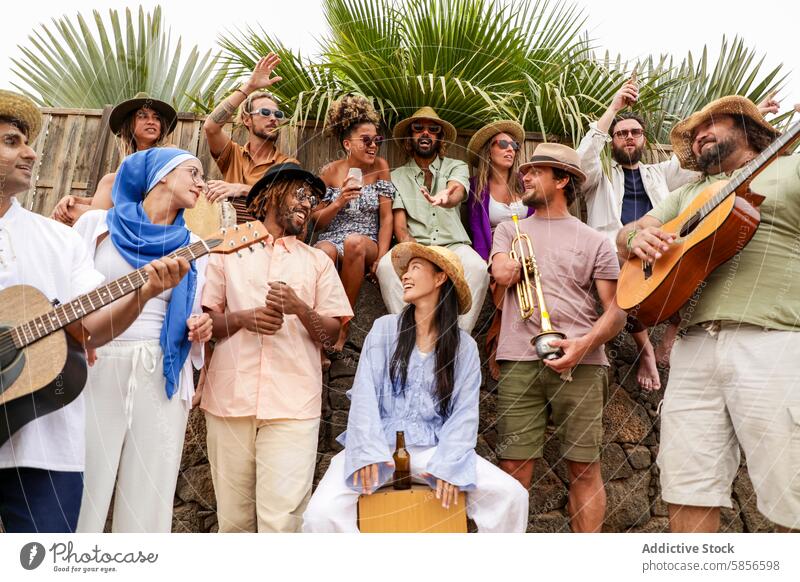 Diverse cheerful group of people enjoying a party with live music outdoors friends guitar laughing multiracial diverse multiethnic men women caucasian smile