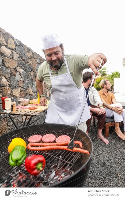 Outdoor barbecue party with friends enjoying food and music outdoor chef conversation grill hat apron cooking meat vegetables atmosphere men sitting relaxing