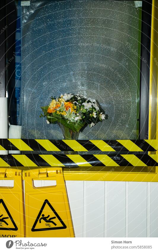 Bouquet of flowers behind barrier tape with warning signs cordon Still Life Warning label Signal colours Signs and labeling Signage slippery Falling down