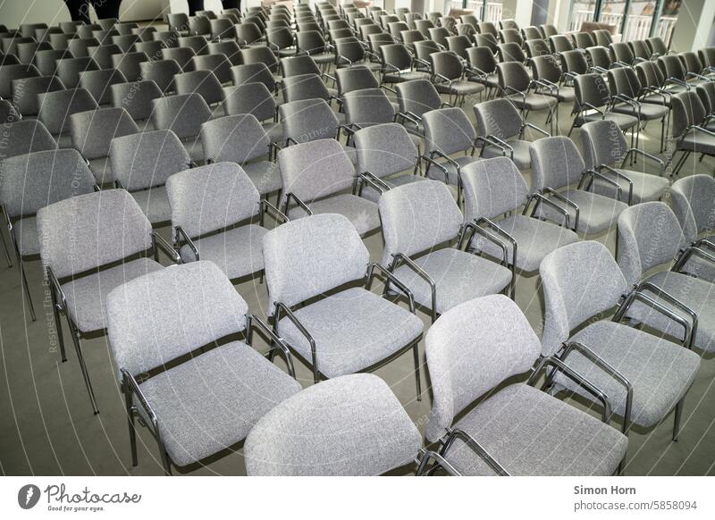 Large, seated area in an interior room, rows of chairs, lecture Lecture Audience Chair rows Event Seating capacity Row of chairs Repeating Side by side