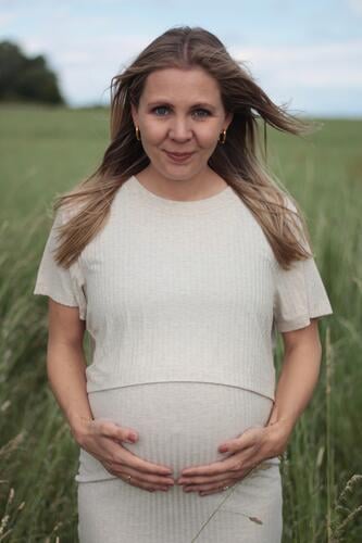 PREGNANCY - HOLDING THE BELLY - SPRING Woman 30 - 35 years long hairs Blonde Pregnant pregnancy Baby bump Modern naturally grasses Green Nature Feminine Wait