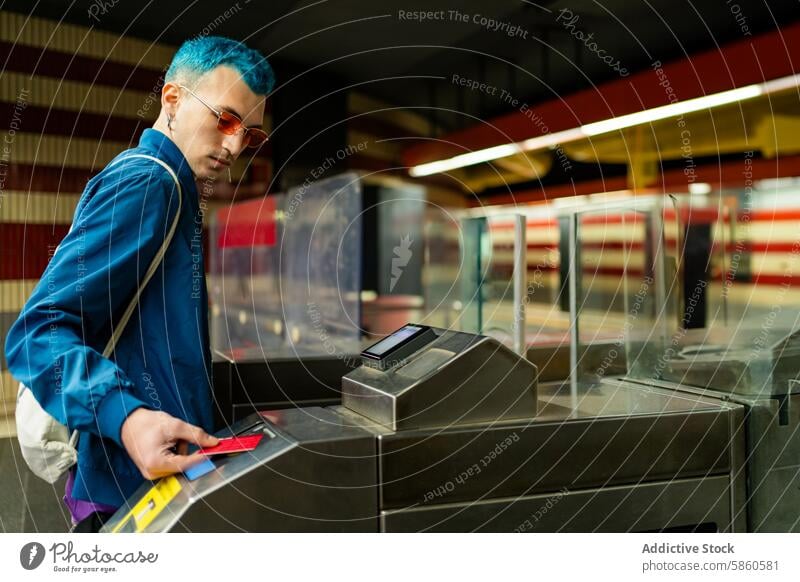 Man with blue hair entering subway station turnstile man ticket style sunglasses casual jacket young fashion accessibility transport gate modern urban travel