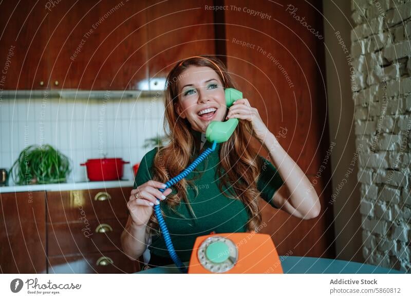 Retro housewife enjoys a lively phone conversation woman redhead 1950s rotary phone kitchen vintage cheerful chatting smiling looking upward telephone turquoise