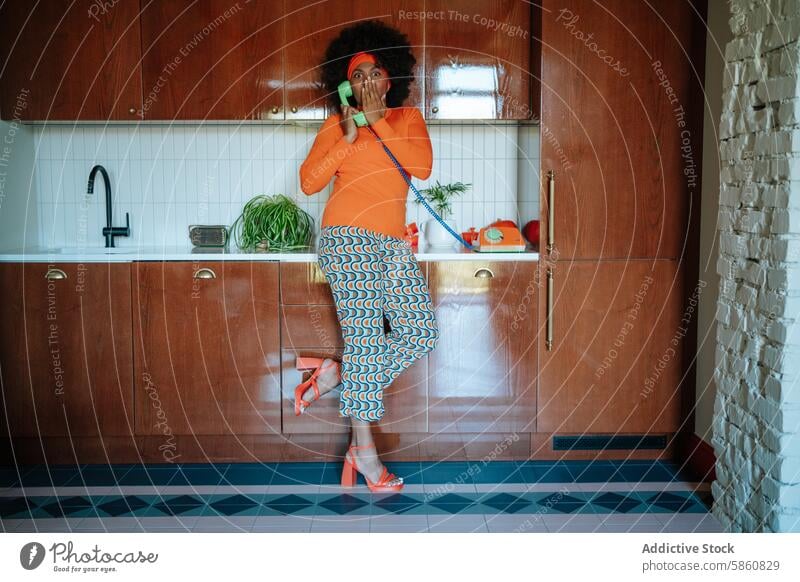 Retro amazed housewife in colorful attire talking shocked on a vintage phone retro woman black telephone kitchen african american vibrant 1950s orange pattern