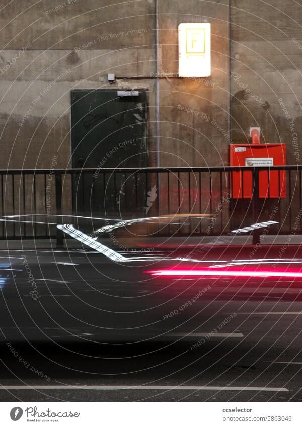 Blurred silhouette of a passing car in an underpass Motoring Transport Road traffic Colour photo Deserted Traffic infrastructure Car motion blur