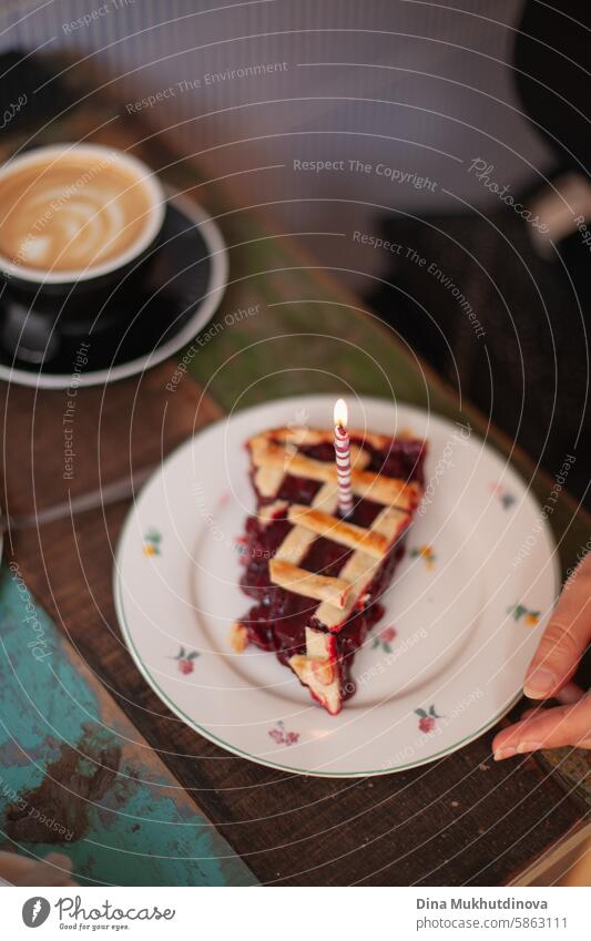 birthday cake cherry pie with a candle, make a wish. celebrating at party. cozy cottage core cafe. flame celebrate Birthday Candle Flame Colour photo