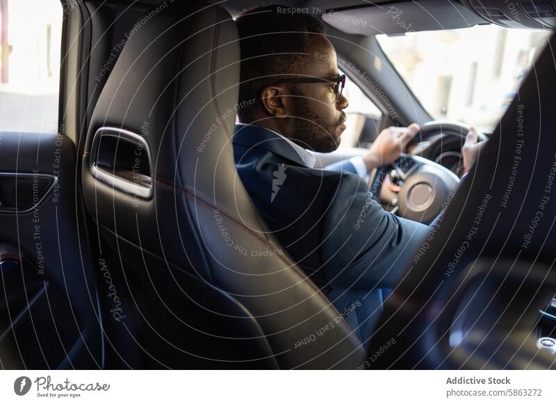 Black businessman driving a car in the city luxury african american male suit glasses vehicle transport steering wheel road urban professional luxury vehicle