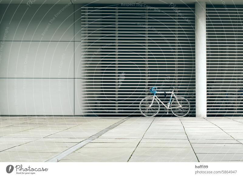 retro vintage racing bike in blue and white in urban monotone surroundings Racing cycle Retro trash retro racing bike Minmalism strictly geometrical