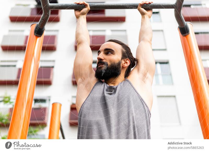 Active lifestyle in Poblenou, man exercising outdoors exercise fitness wellbeing pull-up bar active sport health athletic strength poblenou urban city routine