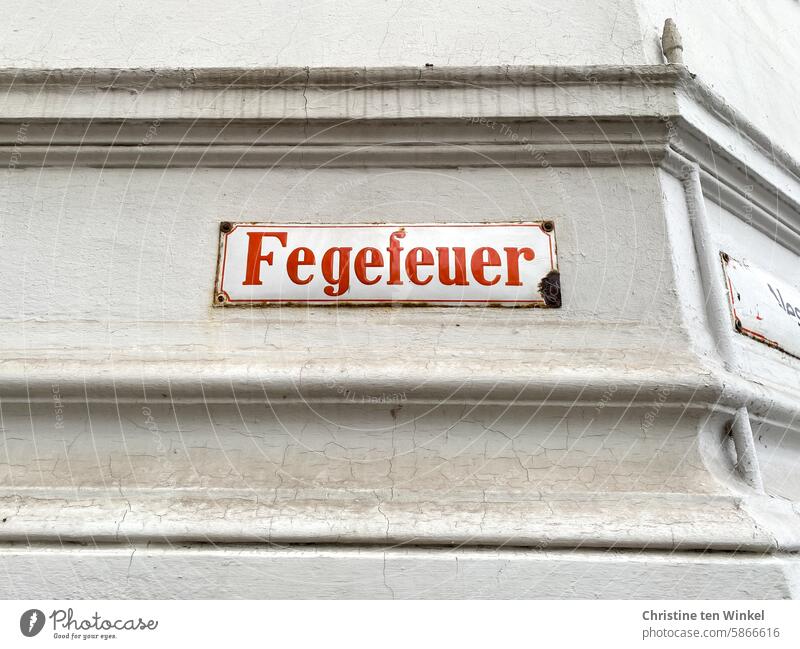 Purgatory / an old street sign in Lübeck on the old town island Old Signs and labeling Orientation street name Street Road marking address designation