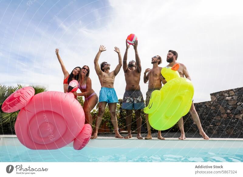 Friends enjoying a pool party with inflatable toys friends summer float swimming multiethnic diverse outdoor fun celebration palm tree water poolside swimwear