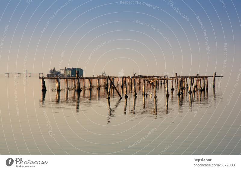 Chioggia lagoon fishing fisher Lagoon canal styles house fishing house pile dwelling chioggia Italian italy adriatic poles sky sunset waves sea scenic