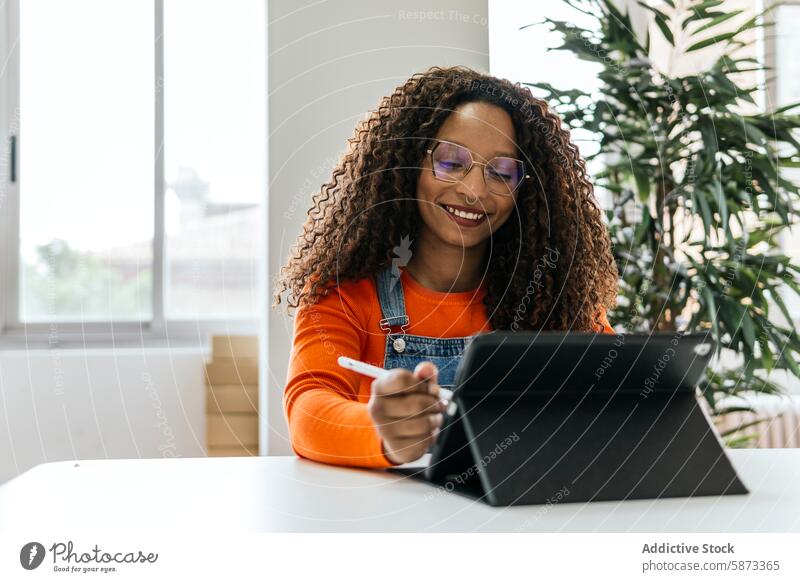 Smiling woman using tablet in bright coworking space african american device gadget office technology smiling female professional workspace modern urban