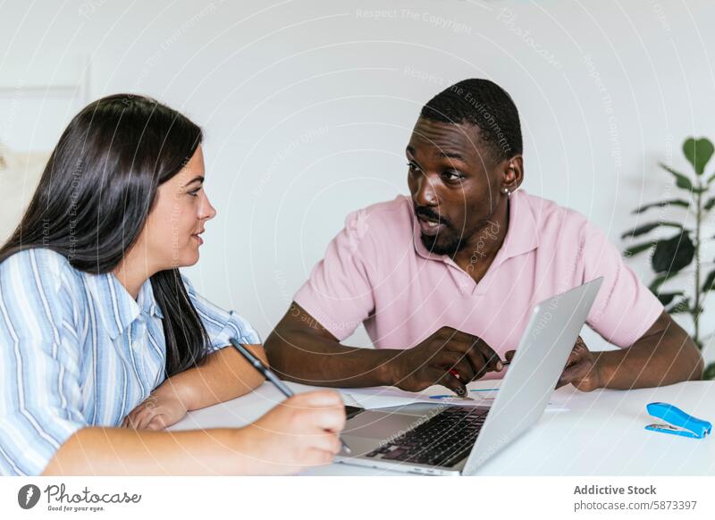 Multiethnic team collaborating at a coworking space collaboration african american hispanic woman conversation multiethnic diverse laptop technology gadget