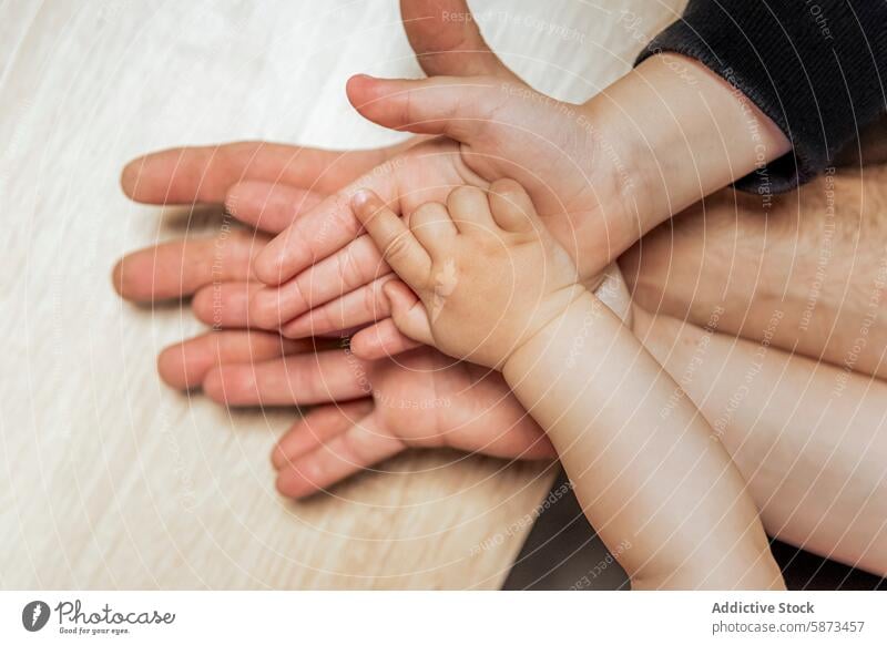 Hands of different generations in a family moment hand anonymous bond unity love close-up connection touch intergenerational child adult care support together