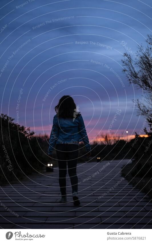 Woman walks along a path at sunset in Barcelona. road Sunset outdoors lifestyle people travel freedom journey vacation happy young relax female Walking tourist